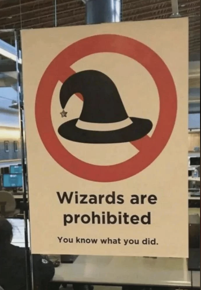 Sign with a wizard hat in a prohibitory circle, text reads "Wizards are prohibited. You know what you did."
