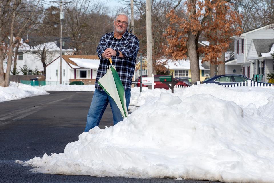 Bob Burger of Point Pleasant Borough and a retired police chief who runs a widely followed Facebook page where he posts weather forecasts, stands in the snow outside of his home in Point Pleasant Borough, NJ Tuesday, February 2, 2022. 