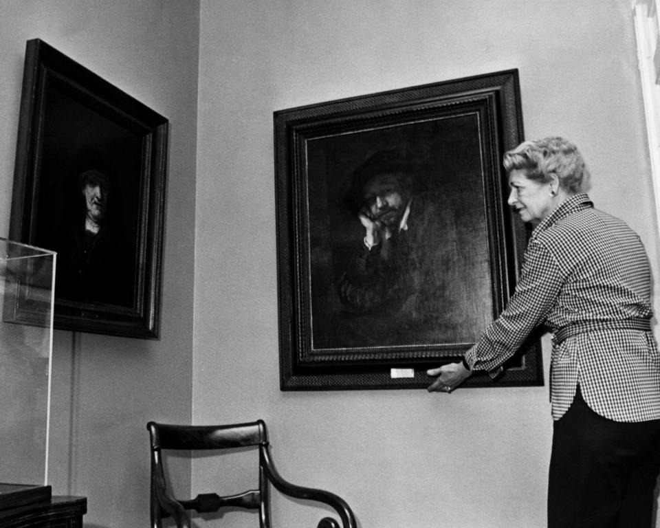 Oct. 23, 1974: "Man Leaning on a Sill" by Rembrandt is restored to the wall at the Taft Museum by Katherine Hannah.