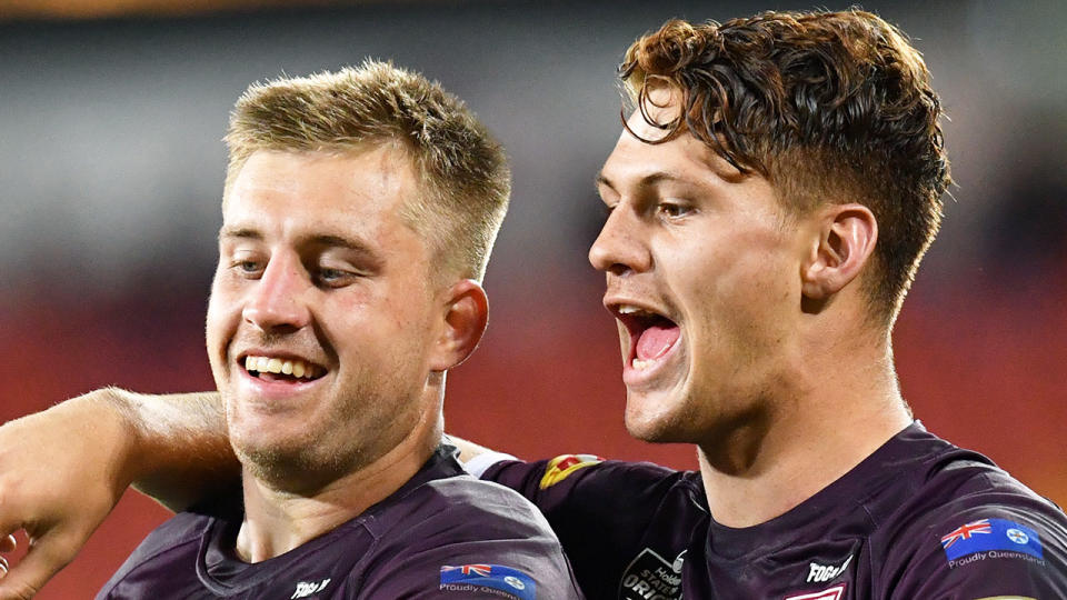 Pictured right is Kalyn Ponga with his Maroons teammate Cameron Munster on the left.