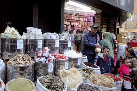 A worker at herbal store takes ingredients to prepare natural herbal drug in Cairo, Egypt January 10, 2017. REUTERS/Mohamed Abd El Ghany