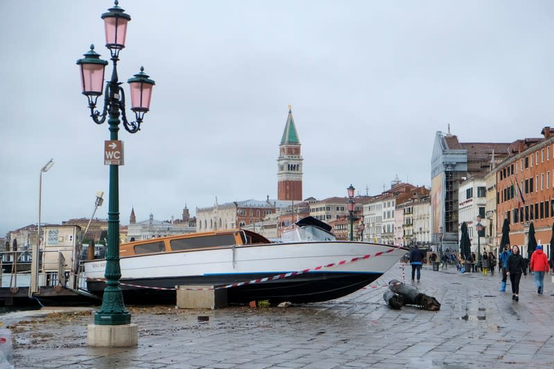 Water taxi transported by the water after a night of record high water levels is seen on the shore in Venice