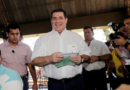 Paraguayan President Horacio Cartes prepares to cast his vote in a polling station during elections in Asuncion, Paraguay, April 22, 2018. REUTERS/Mario Valdez