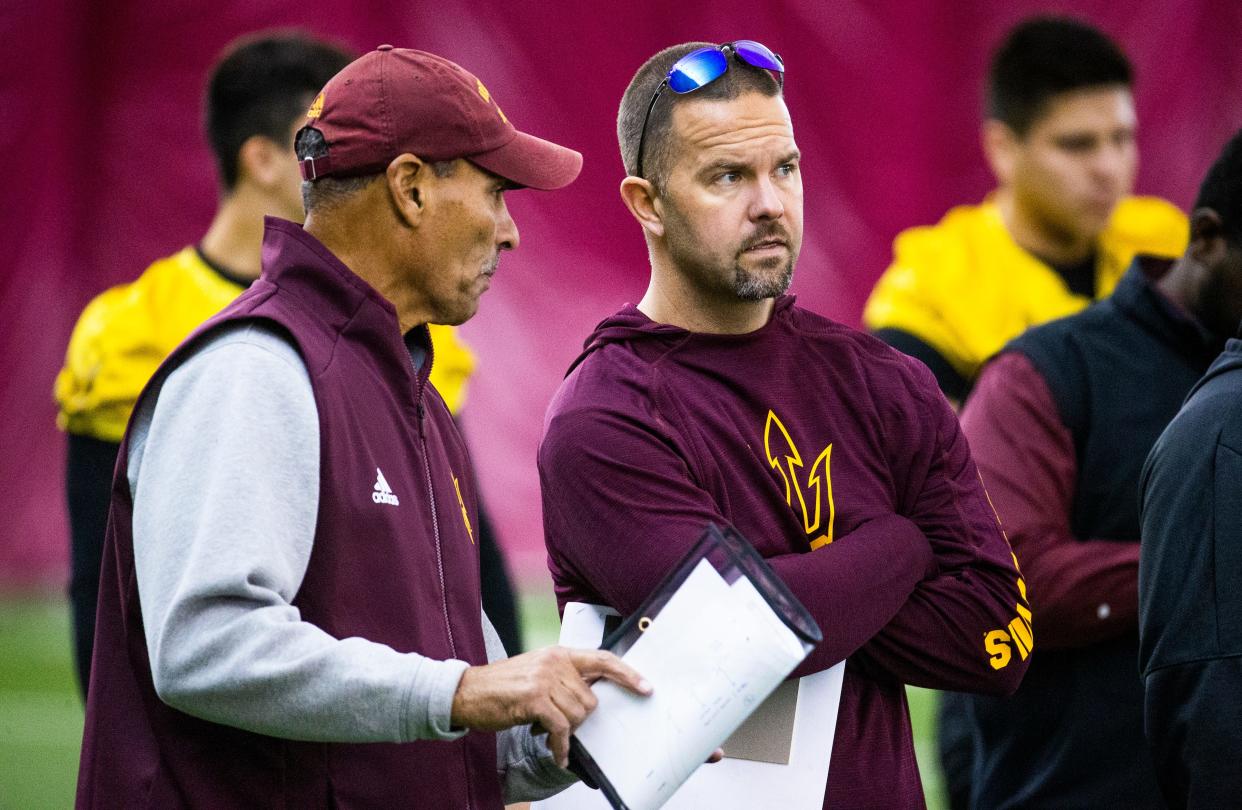 Arizona State University head football coach Herm Edwards speaks with newly hired offensive coordinator Zak Hill during practice at the Verde Dickey Dome on campus in Tempe, Tuesday, December 17, 2019.