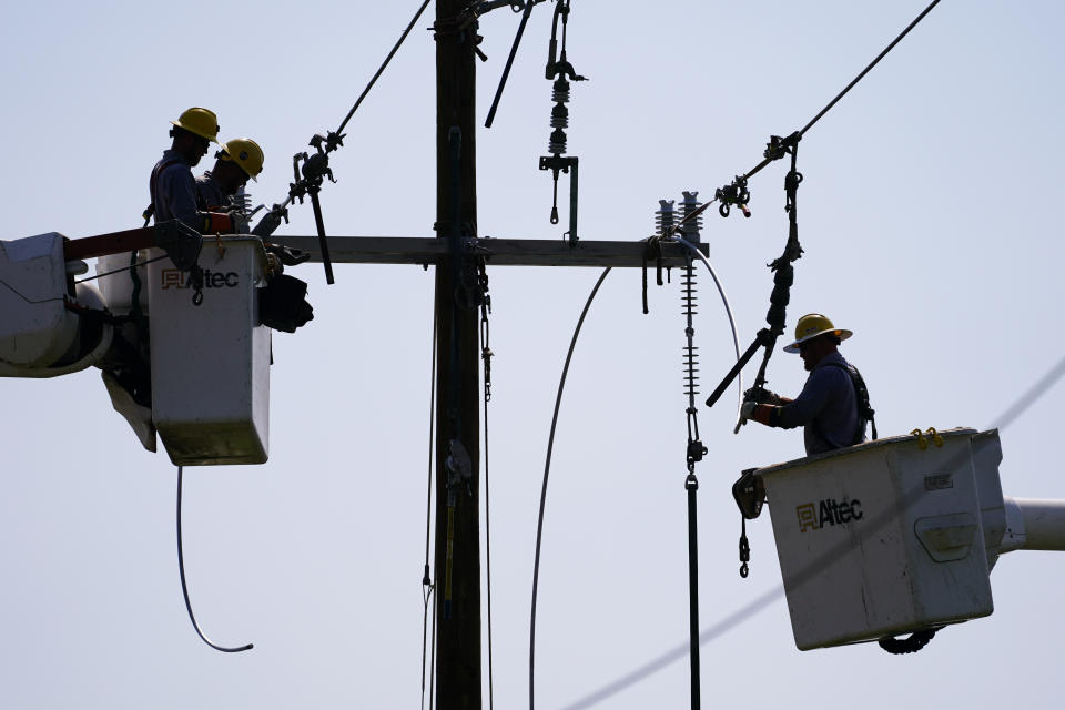 Crews work on power lines that were damaged in the aftermath of Hurricane Ida, Friday, Sept. 3, 2021, in LaPlace, La.Power out, high voltage lines on the ground, maybe weeks until electricity is restored in some places _ it's a distressingly familiar situation for Entergy Corp., Louisiana's largest electrical utility. Entergy is hardly alone. (AP Photo/Matt Slocum)