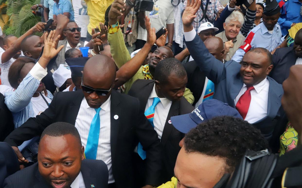 Congolese opposition leader Jean-Pierre Bemba waves to supporters of the Movement for the Liberation of the Congo as he arrives at the N'djili International Airport in Kinshasa - REUTERS