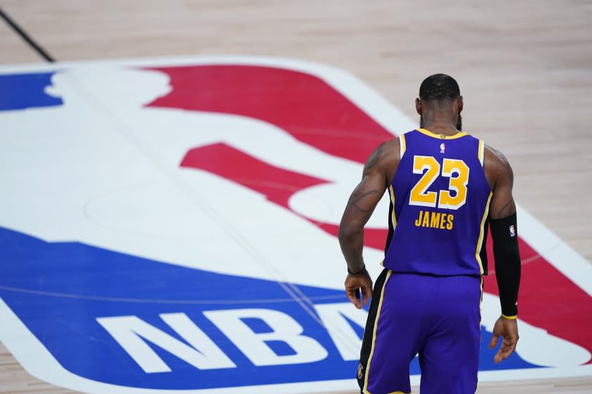 Los Angeles Lakers forward LeBron James (23) walks across the court during the first half of an NBA basketball first round playoff game against the Portland Trail Blazers, Saturday, Aug. 22, 2020, in Lake Buena Vista, Fla. (AP Photo/Ashley Landis, Pool)