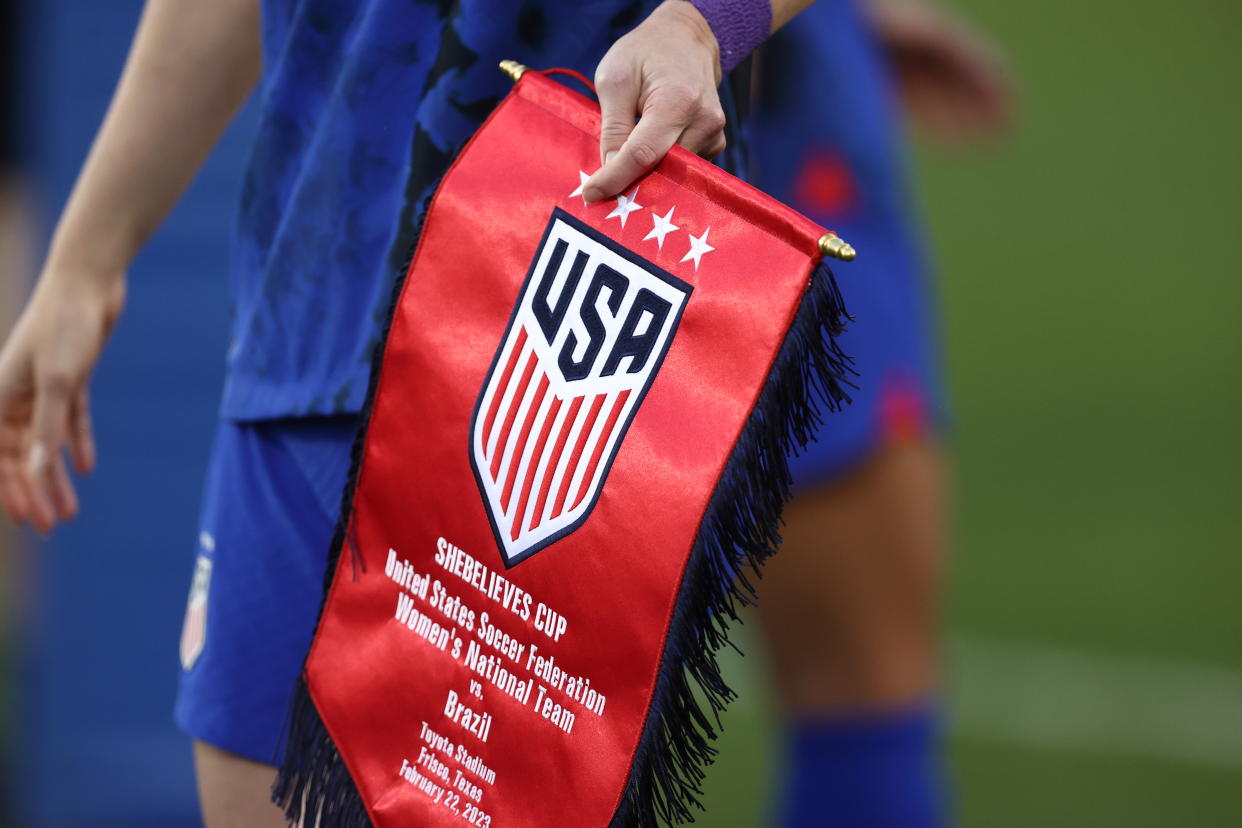 FRISCO, TX - FEBRUARY 22: Becky Sauerbrunn of United States holding a us pennant during the SheBelieves Cup match between Brazil and United States at Toyota Stadium on February 22, 2023 in Frisco, Texas. (Photo by James Williamson - AMA/Getty Images)