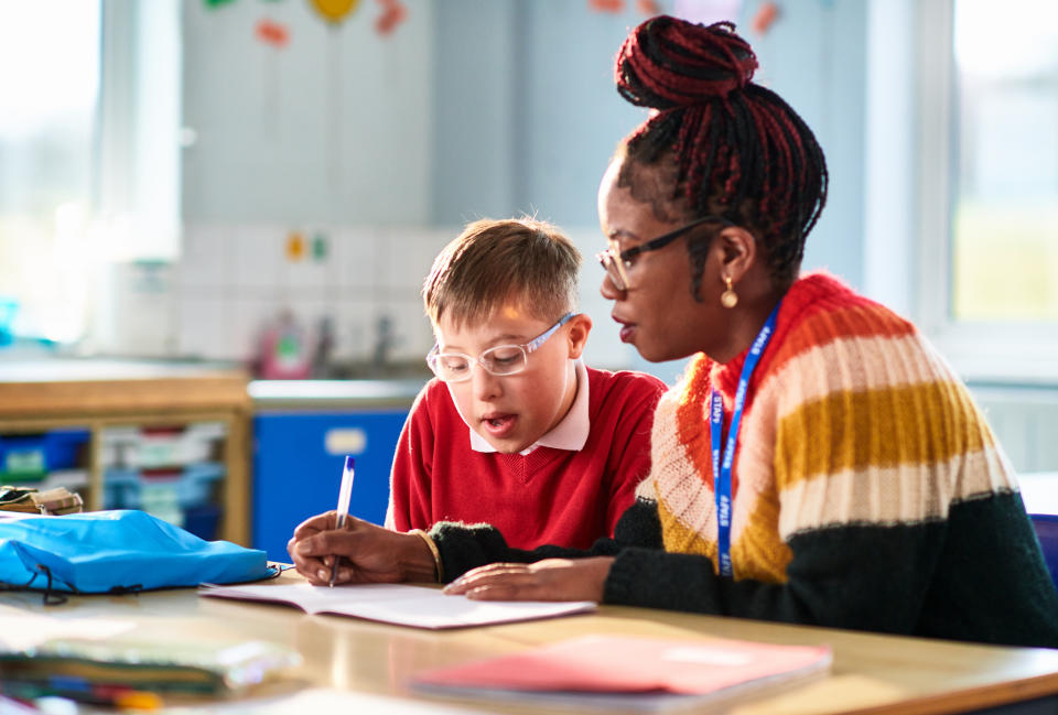 A teacher helps a special education student