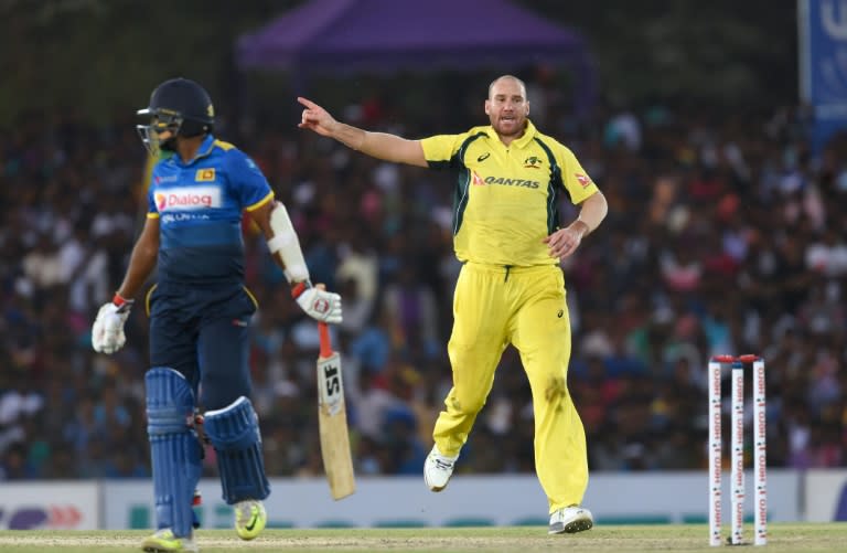 Australia's John Hastings (R) celebrates the dismissal of Sri Lanka cricketer Dilruwan Perera during the fourth one-day international in Dambulla on August 31, 2016