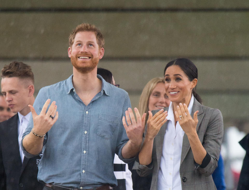 The Duke and Duchess of Sussex look out at a heavy downpour of rain during a visit to Clontarf Foundation and Girls Academy in Dubbo, New South Wales, on the second day of the royal couple's visit to Australia. (Photo by Dominic Lipinski/PA Images via Getty Images)