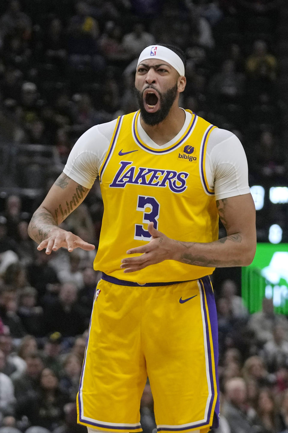 Los Angeles Lakers forward Anthony Davis shouts to a teammate during the first half of the Lakers' NBA basketball game against the Utah Jazz on Wednesday, Feb. 14, 2024, in Salt Lake City. (AP Photo/Rick Bowmer)