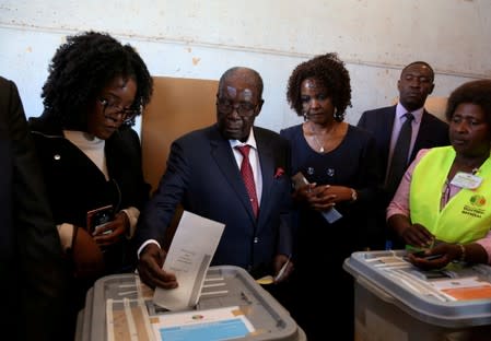 FILE PHOTO: Zimbabwe's former president Robert Mugabe casts his ballot in the general elections in Harare