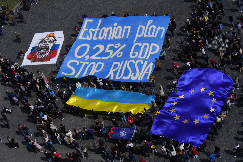 People perform during a demonstration in support of Estonian military strategic plan for Ukraine at the Old Town Square in Prague, Czech Republic, Sunday, April 21, 2024. (AP Photo/Petr David Josek)
