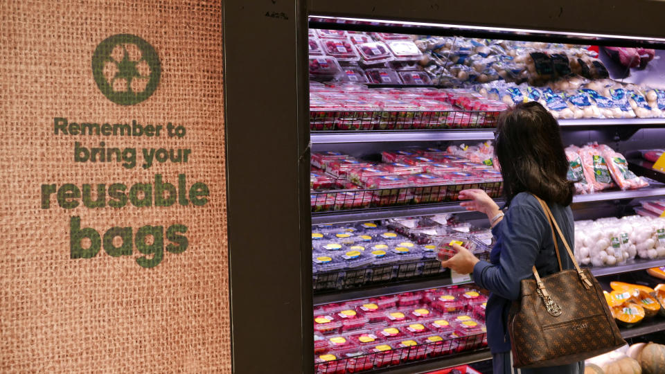 A shopper selects items inside a plastic bag-free Woolworths supermarket. Source: Reuters