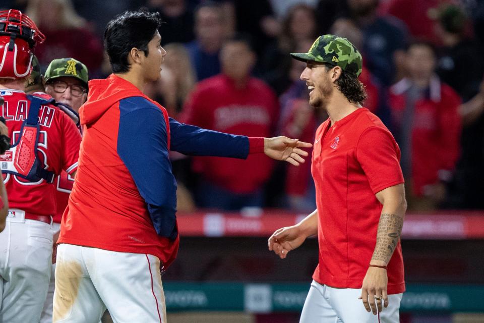 Los Angeles Angels' Shohei Ohtani, left, congratulates relief pitcher Michael Lorenzen after the Angels defeated the Oakland Athletics 5-3 in a baseball game in Anaheim, Calif., Saturday, May 21, 2022. (AP Photo/Alex Gallardo)