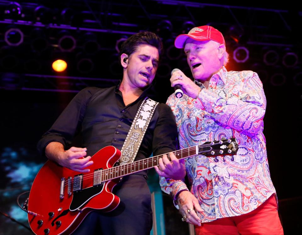 John Stamos (left) and original Beach Boys member Mike Love (right) performed with The Beach Boys Band at the Ohio State Fair in 2014 in Columbus.