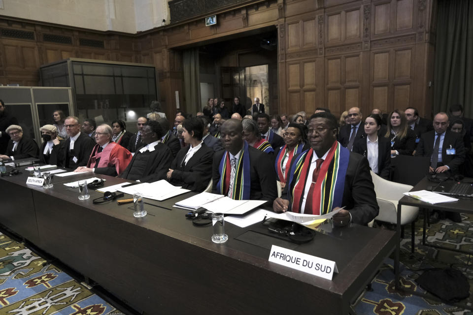 Ambassador of the Republic of South Africa to the Netherlands Vusimuzi Madonsela, front right, and Minister of Justice and Correctional Services of South Africa Ronald Lamola, front second right, during the opening of the hearings at the International Court of Justice in The Hague, Netherlands, Thursday, Jan. 11, 2024. The United Nations' top court opens hearings Thursday into South Africa's allegation that Israel's war with Hamas amounts to genocide against Palestinians, a claim that Israel strongly denies. (AP Photo/Patrick Post)