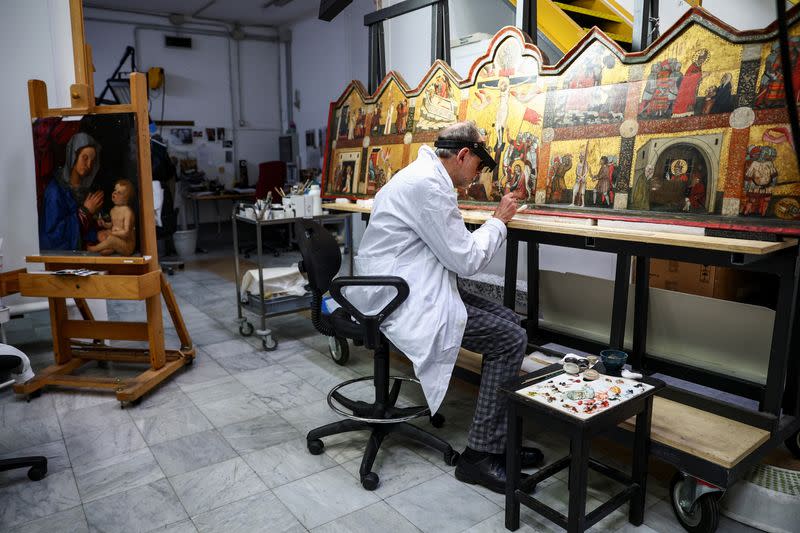 Art restorers work at the "painting and wood materials restoration laboratory" in the Vatican Museums, at the Vatican