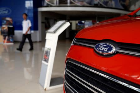 A worker walks near a Ford Ecosport at the Central Jakarta Ford Dealer in Jakarta, Indonesia, June 27, 2016. REUTERS/Beawiharta