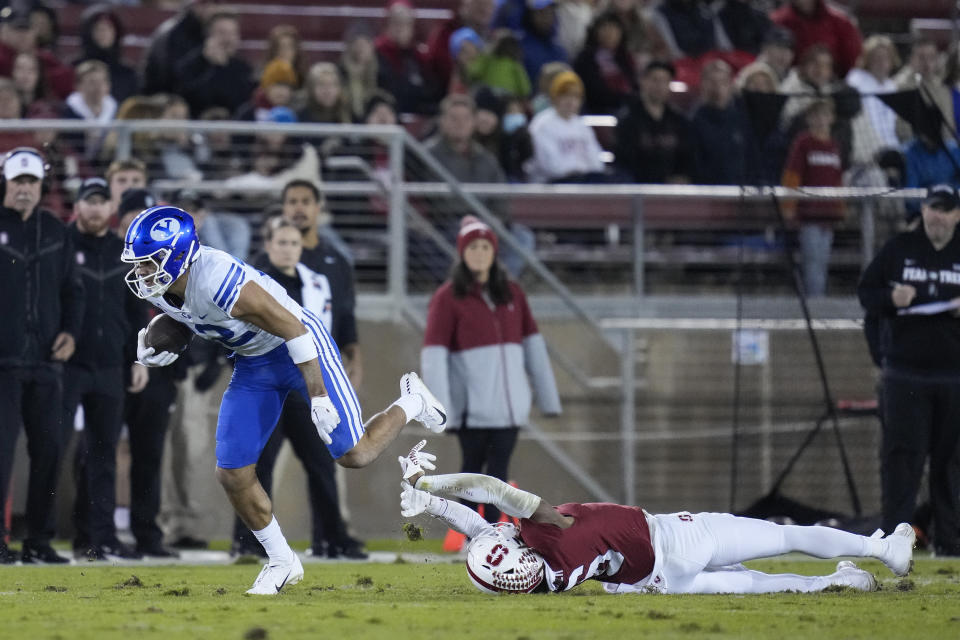 BYU wide receiver Puka Nacua, left, avoids a tackle attempt by Stanford cornerback Nicolas Toomer during the first half of an NCAA college football game in Stanford, Calif., Saturday, Nov. 26, 2022. (AP Photo/Godofredo A. Vásquez)