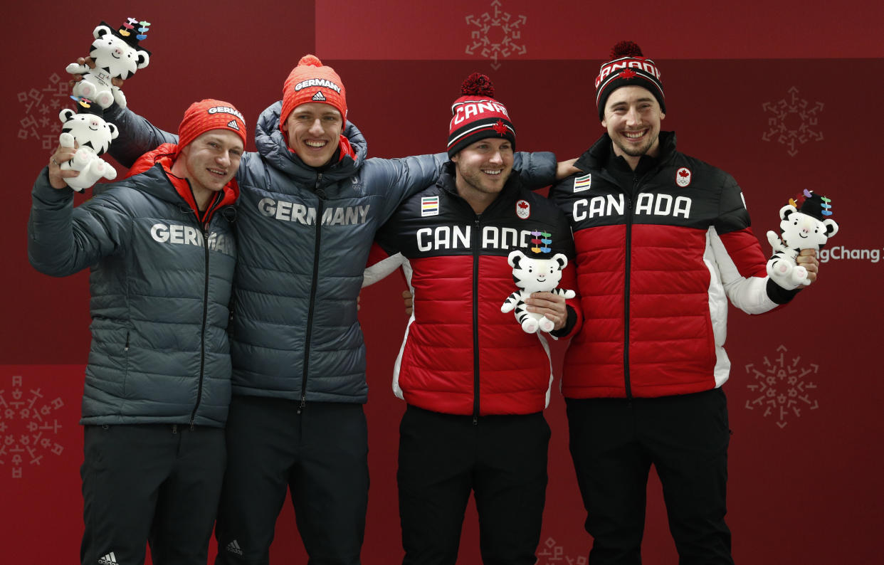 Francesco Friedrich (far left) and Thorsten Margis of Germany shared gold medals on Monday with Alexander Kopacz (far right) and Justin Kripps of Canada in the two-man bobsled race at the Winter Olympics. (Photo: Edgar Su / Reuters)
