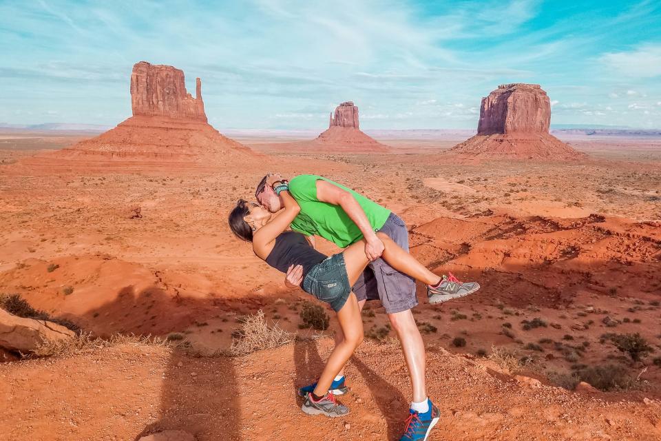 <p>Husband and wife Rob and Joli Switzer perform their dip-kiss pose in Monument Valley in Utah and Arizona. (Caters News) </p>