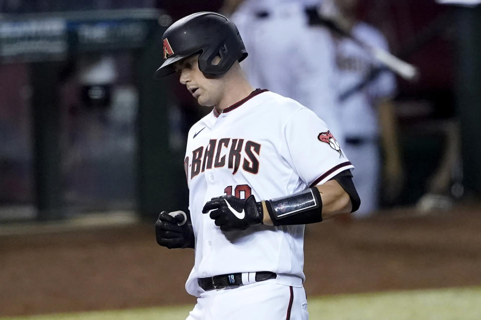 Arizona Diamondbacks' Carson Kelly crosses the plate after hitting a two run home run against the Los Angeles Dodgers during the sixth inning of a baseball game, Thursday, Sept. 10, 2020, in Phoenix. (AP Photo/Matt York)