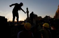 Demonstrators block Al Shuhada bridge during ongoing anti-government protests, in Baghdad