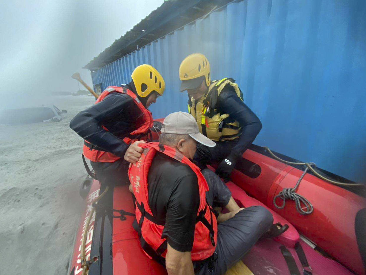 Rescuers assist with evacuations during floods after Typhoon Gaemi made landfall in Taiwan on Thursday.  