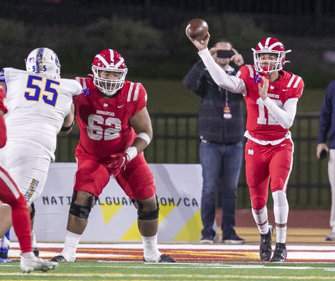 Mission Viejo, CA - December 11: Mater Dei quarterback Elijah Brown throws the ball against San Mateo Serra defenders in the first quarter, part of the 2021 CIF State Football Championship Bowl Games - Open Division tournament in Saddleback College, Mission Viejo, CA on Saturday, Dec. 11, 2021. (Allen J. Schaben / Los Angeles Times)