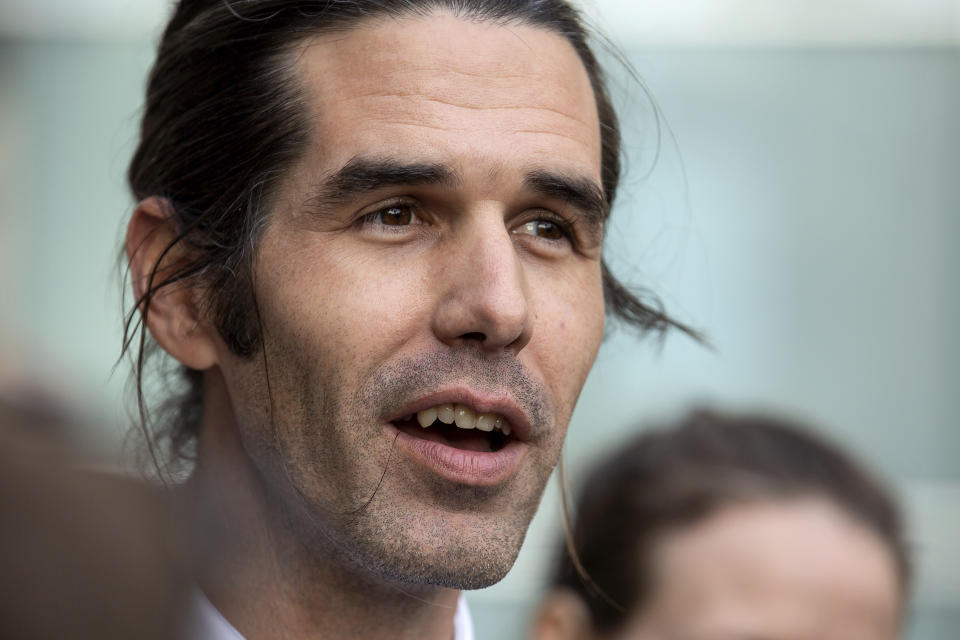 Border aid volunteer Scott Warren talks with media and supporters outside the Federal Courthouse, Wednesday, Nov. 20, 2019 in Tucson, Ariz. Warren was acquitted Wednesday on charges he illegally harbored two Central American immigrants at a camp in southern Arizona operated by a humanitarian group. (Josh Galemore/Arizona Daily Star via AP)