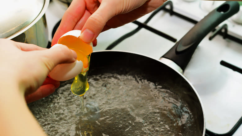 Breaking egg into boiling water