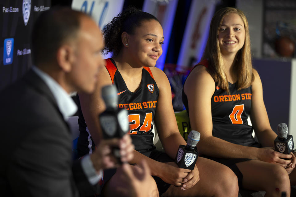 Oregon State head coach Scott Rueck, from left, along with players Destiny Slocum and Mikayla Pivec, speaks to reporters during the Pac-12 Conference Women's NCAA College Basketball Media Day, Monday, Oct. 7, 2019 in San Francisco. (AP Photo/D. Ross Cameron)