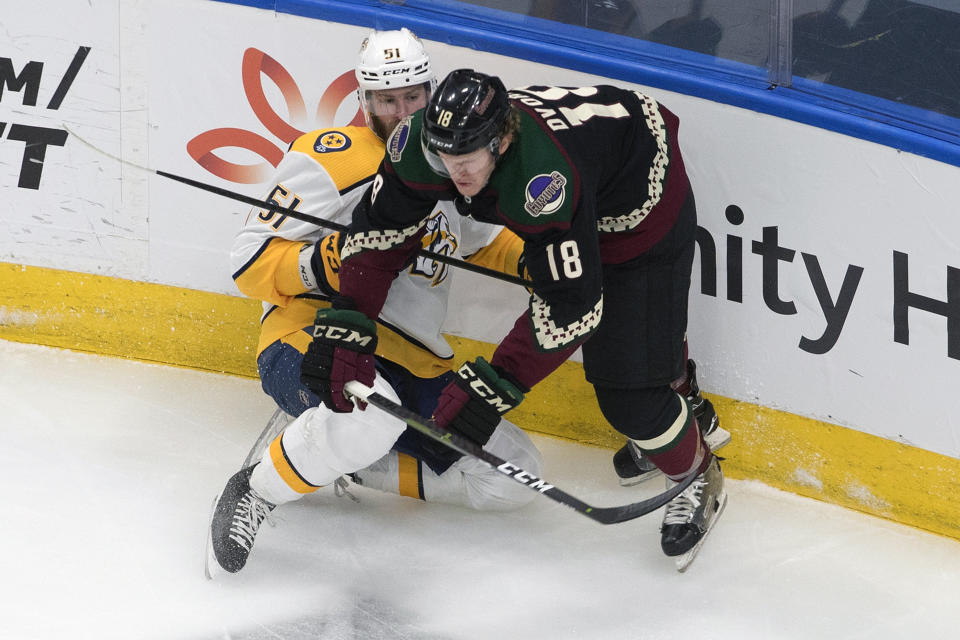 Nashville Predators' Austin Watson (51) is checked by Arizona Coyotes' Christian Dvorak (18) during first period NHL hockey action in Edmonton, Alberta, Friday, Aug. 7, 2020. (Jason Franson/The Canadian Press via AP)