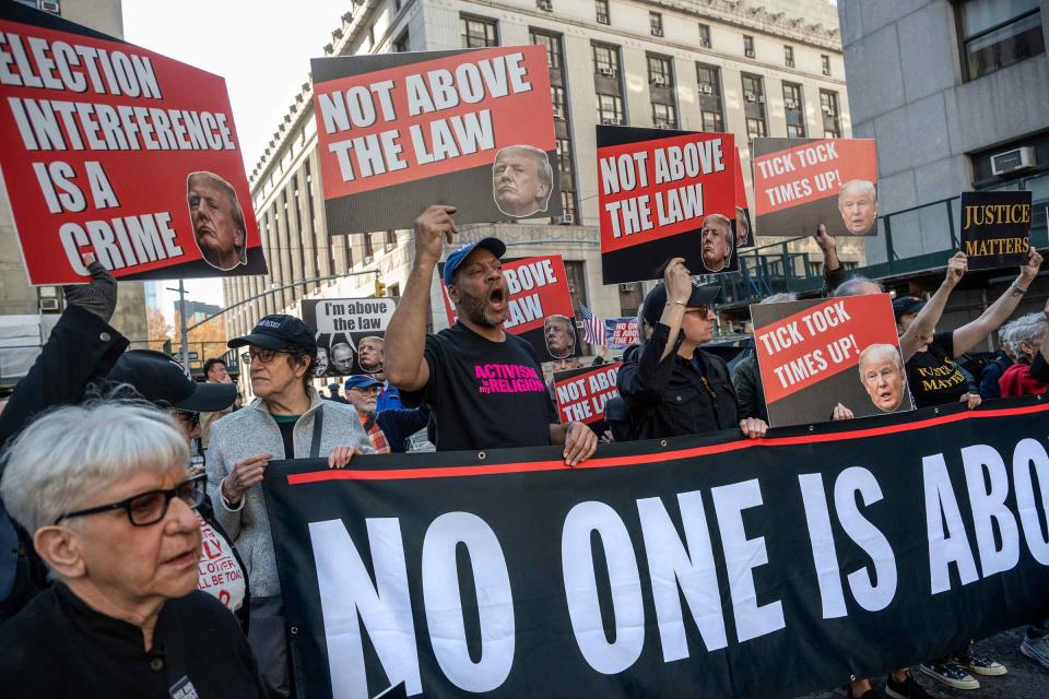 Opponents of former president Donald Trump protest on the first day of his trial in New York City on Monday, April 15, 2024. <span class="copyright">Victor J. Blue for TIME</span>