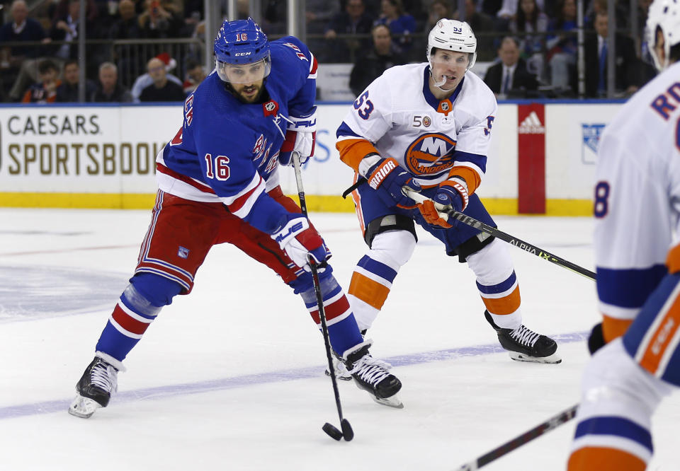 New York Rangers center Vincent Trocheck (16) skates past New York Islanders center Casey Cizikas (53) during the first period of an NHL hockey game Thursday, Dec. 22, 2022, in New York. (AP Photo/John Munson)