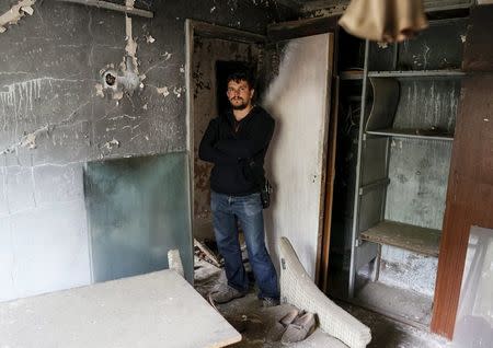 Roman Chernyavskiy, 32, poses for a photograph in his flat which was evacuated after an explosion at the Chernobyl nuclear power plant, in the ghost town of Pripyat, Ukraine April 18, 2016. REUTERS/Gleb Garanich