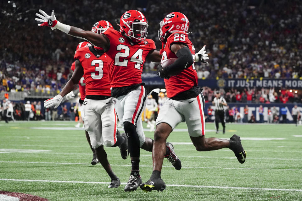 Georgia defensive back Malaki Starks (24) reacts as Georgia defensive back Christopher Smith (29) returns a blocked LSU field goal attempt for a touchdown in the first half of the Southeastern Conference Championship football game Saturday, Dec. 3, 2022 in Atlanta. (AP Photo/John Bazemore)