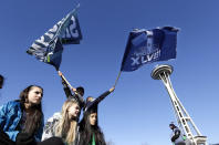 Seattle Seahawks fans cheer as they wait for the Super Bowl champions parade to begin Wednesday, Feb. 5, 2014, in Seattle. The Seahawks beat the Denver Broncos 43-8 in NFL football's Super Bowl XLVIII on Sunday.(AP Photo/Elaine Thompson)