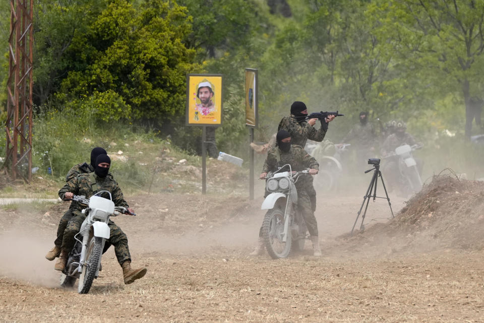 Fighters from the Lebanese militant group Hezbollah carry out a training exercise in Aaramta village in the Jezzine District, southern Lebanon, Sunday, May 21, 2023. The show of force came ahead of "Liberation Day," the annual celebration of the withdrawal of Israeli forces from south Lebanon on May 25, 2000, and in the wake of a recent escalation of the Israel-Palestine conflict in the Gaza Strip. (AP Photo/Hassan Ammar)