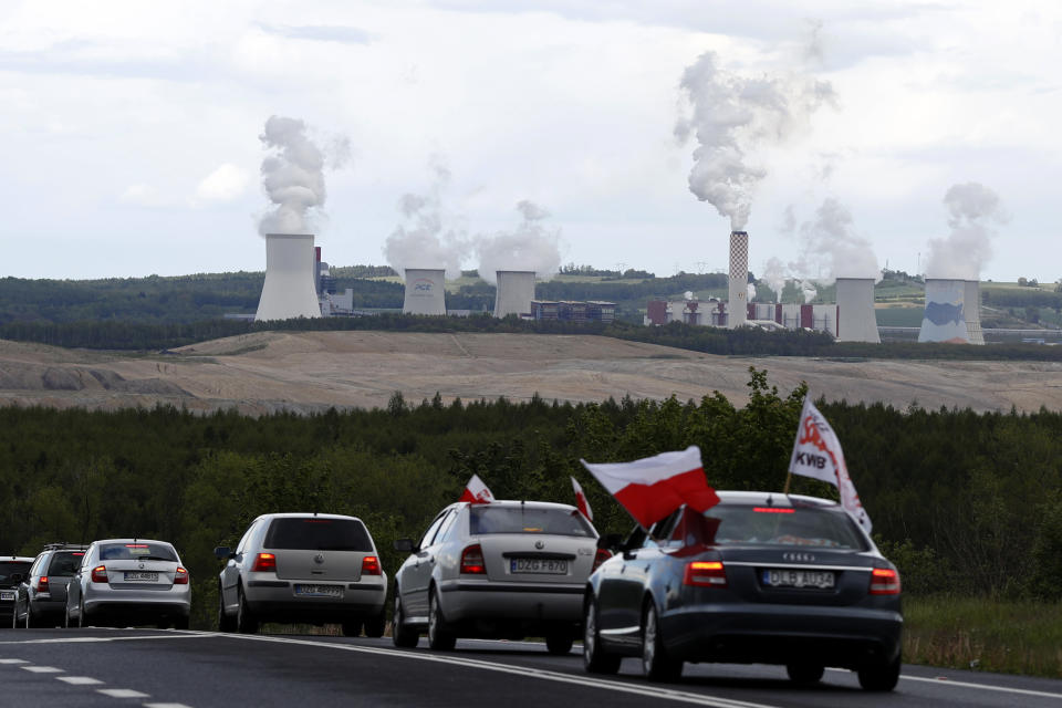 FILE - Cars drive slowly to block a border between Czech Republic and Poland near the Turow coal mine near Bogatynia, Poland, Tuesday, May 25, 2021. (AP Photo/Petr David Josek, File)