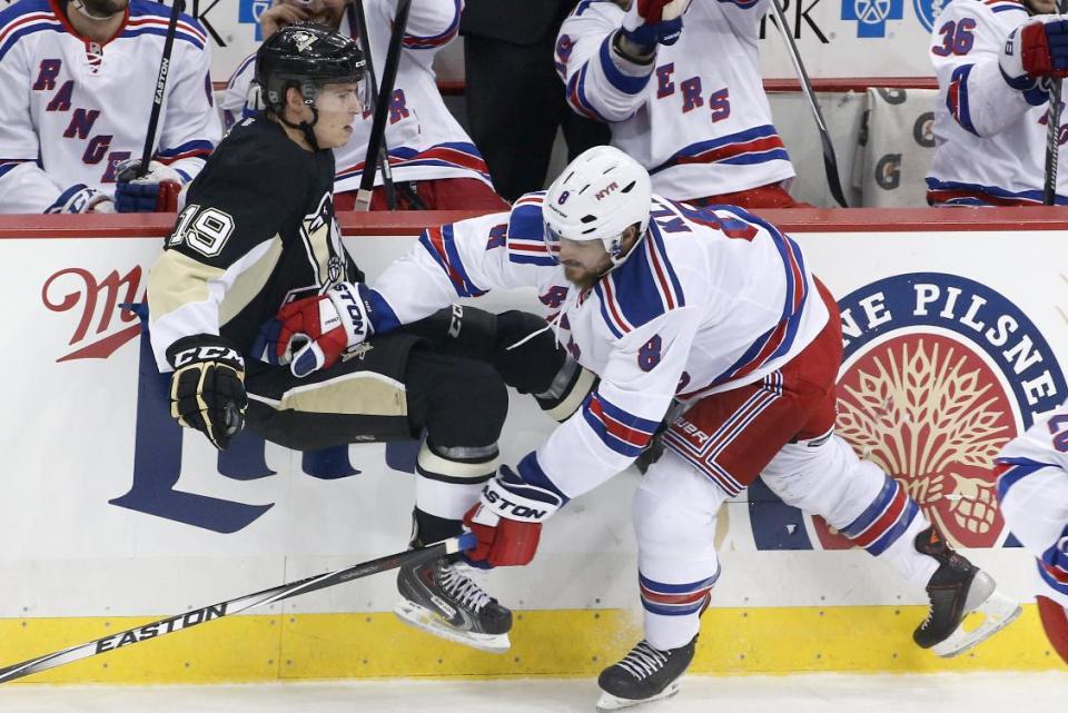 Pittsburgh Penguins' Beau Bennett (19) is checked off the puck by New York Rangers' Kevin Klein (8) in the first period of Game 5 of a second-round NHL playoff hockey series in Pittsburgh, Friday, May 9, 2014. (AP Photo/Gene J. Puskar)