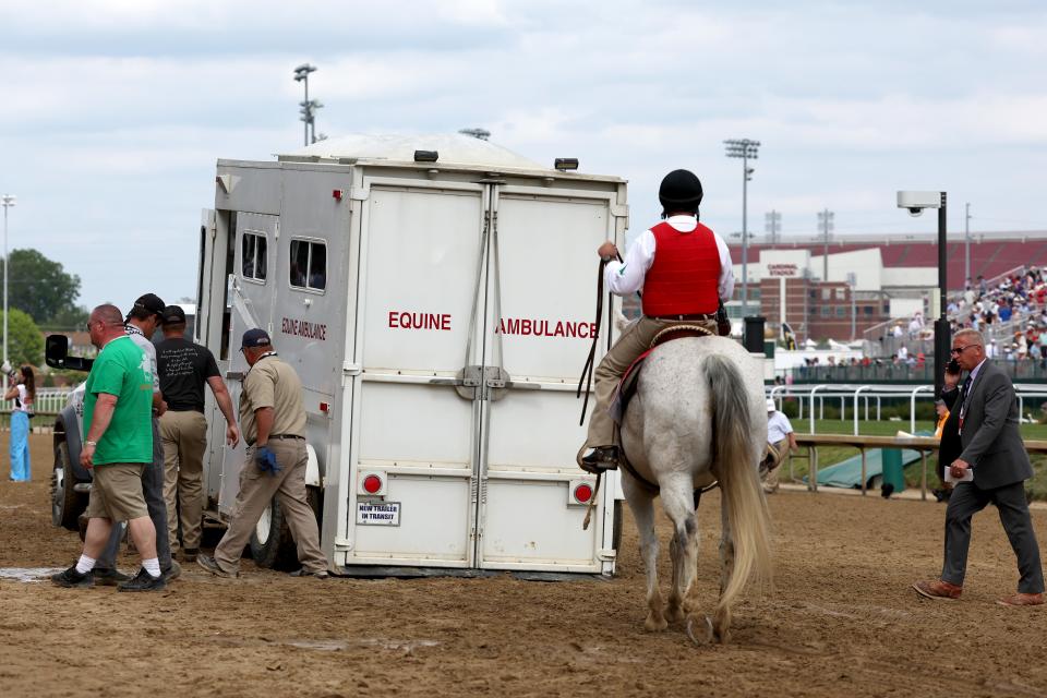 An equine ambulance carrying Here Mi Song is driven off the track after racing in the 10th race ahead of the 149th Kentucky Derby. The horse survived.