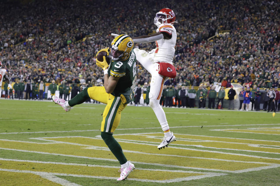 Green Bay Packers wide receiver Christian Watson (9) catches a 12-yard touchdown pass as Kansas City Chiefs cornerback Joshua Williams (2) defends during the second half of an NFL football game Sunday, Dec. 3, 2023 in Green Bay, Wis. (AP Photo/Matt Ludtke)