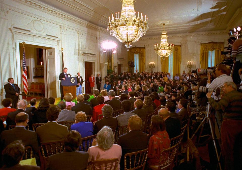 In this March 23, 1993, photo, members of the media fill the East Room of the White House during President Bill Clinton's first formal news conference since taking office.