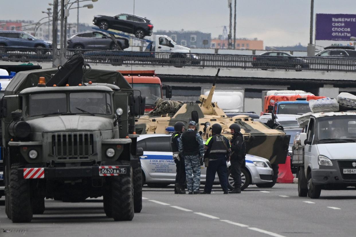 Police officers stand on the highway on the outskirts of Moscow, (AP)