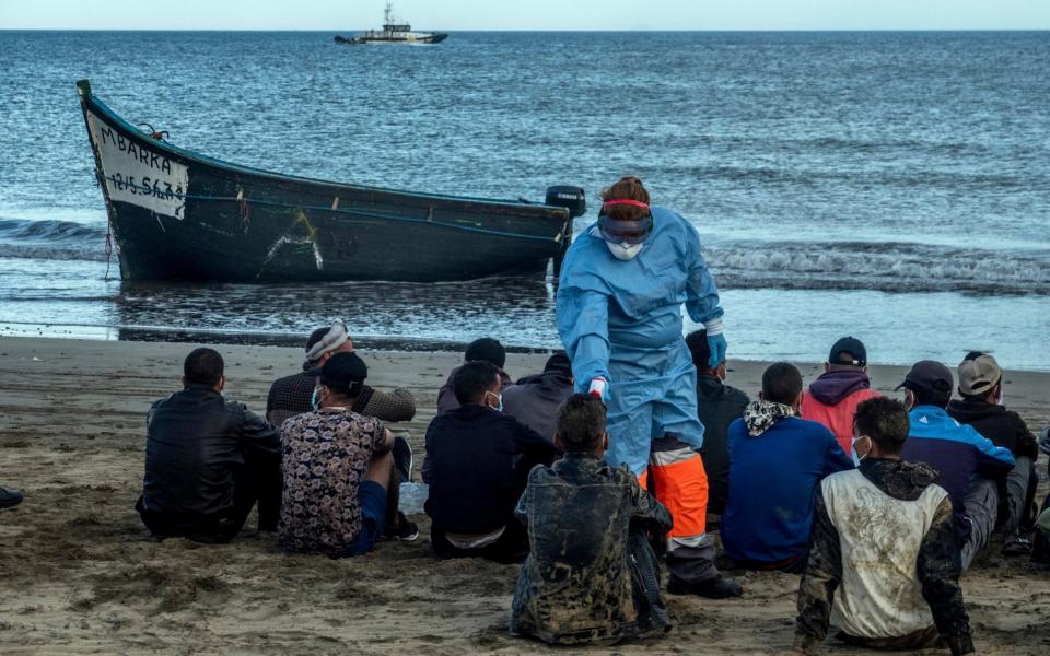 Migrants from Morocco have their temperature checked because of the coronavirus, after arriving at the coast of the Canary Islands - AP 