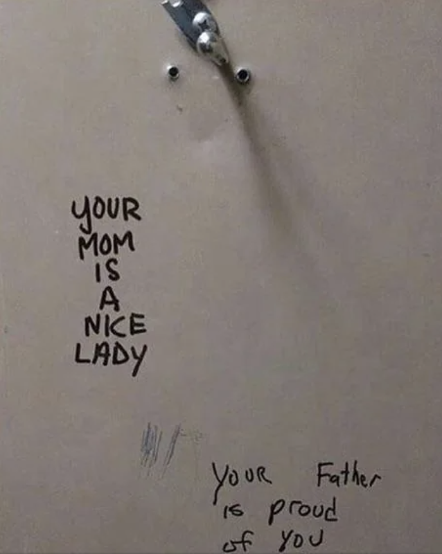 Graffiti message on a wall says, "Your mom is a nice lady" and another message below says, "Your father is proud of you."