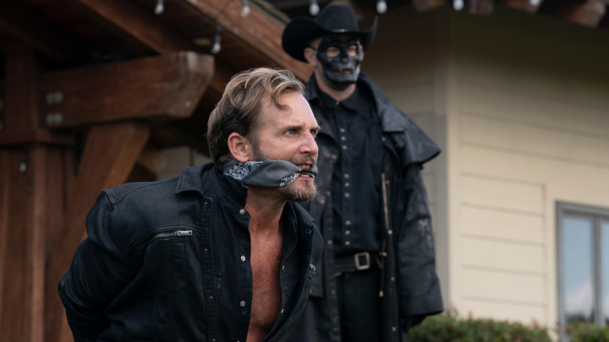  Josh Lucas struggles as he's bound in front of a Purger in The Forever Purge. 